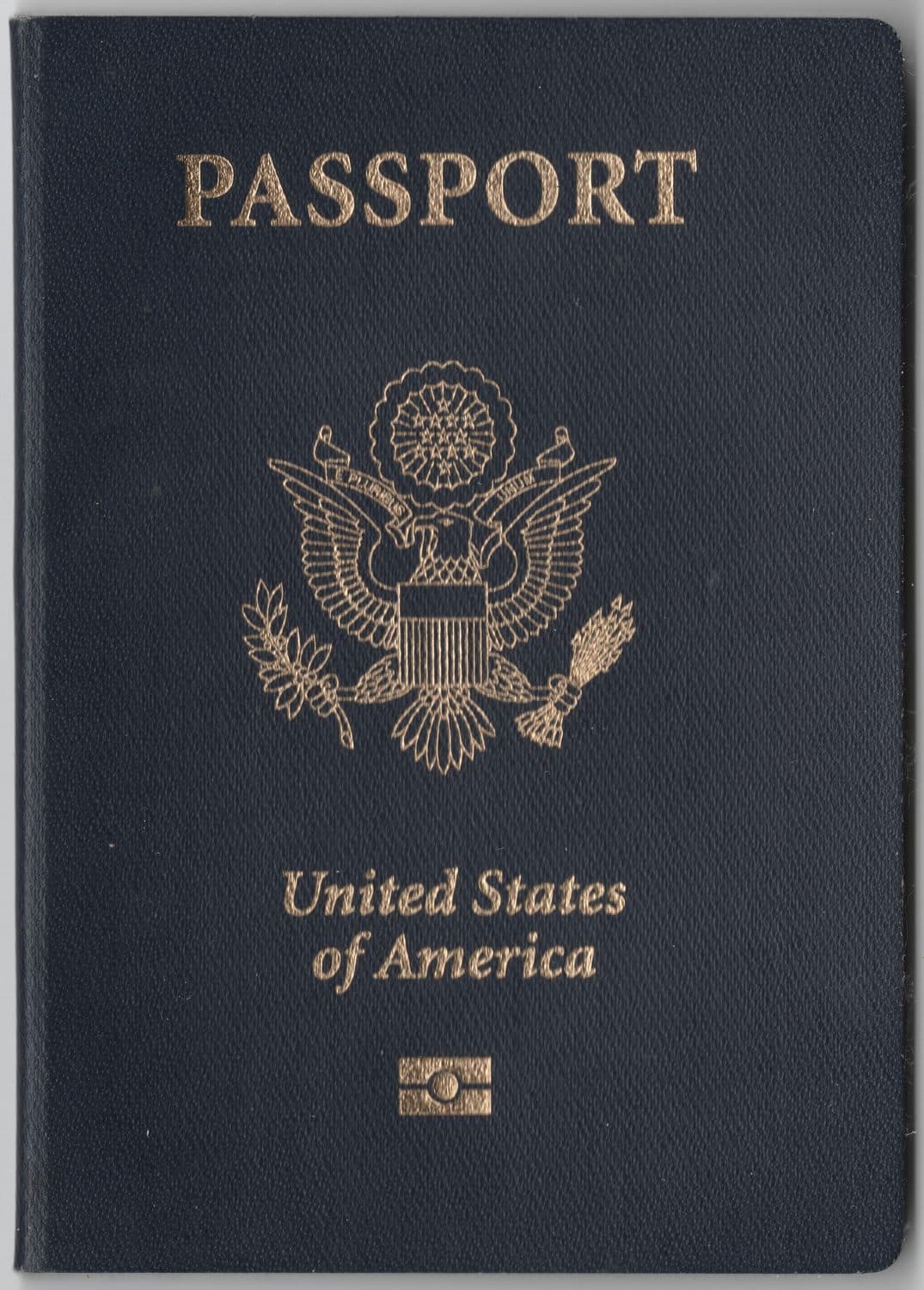 The dark blue cover of a United States passport with the gold eagle seal