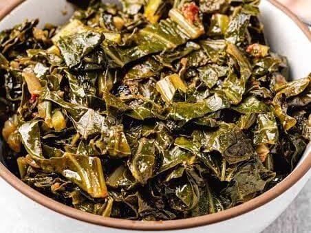 A bowl of dark, glossy cooked collard greens