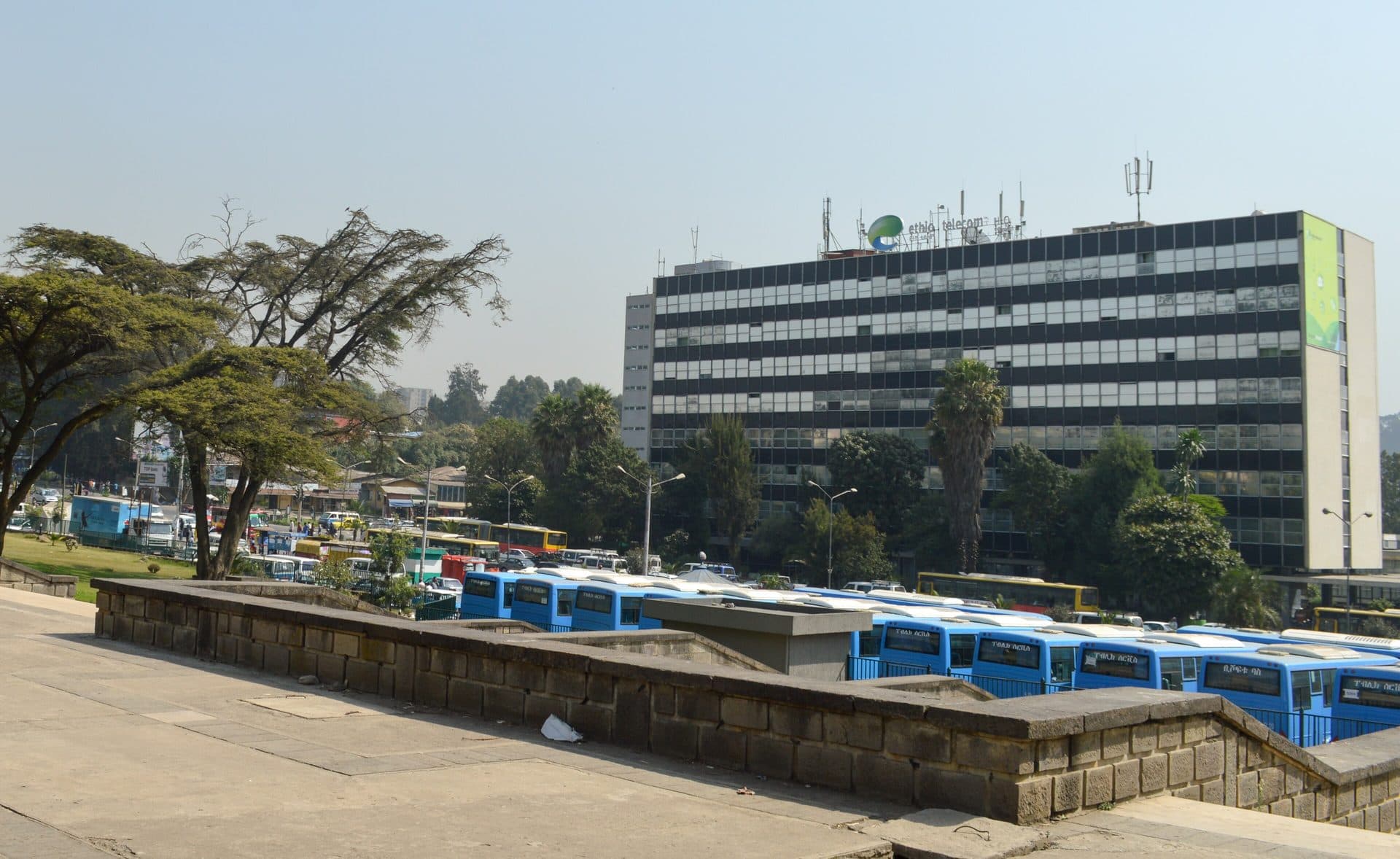 The Ethio Telecom office building in Addis Ababa with blue city buses parked in front