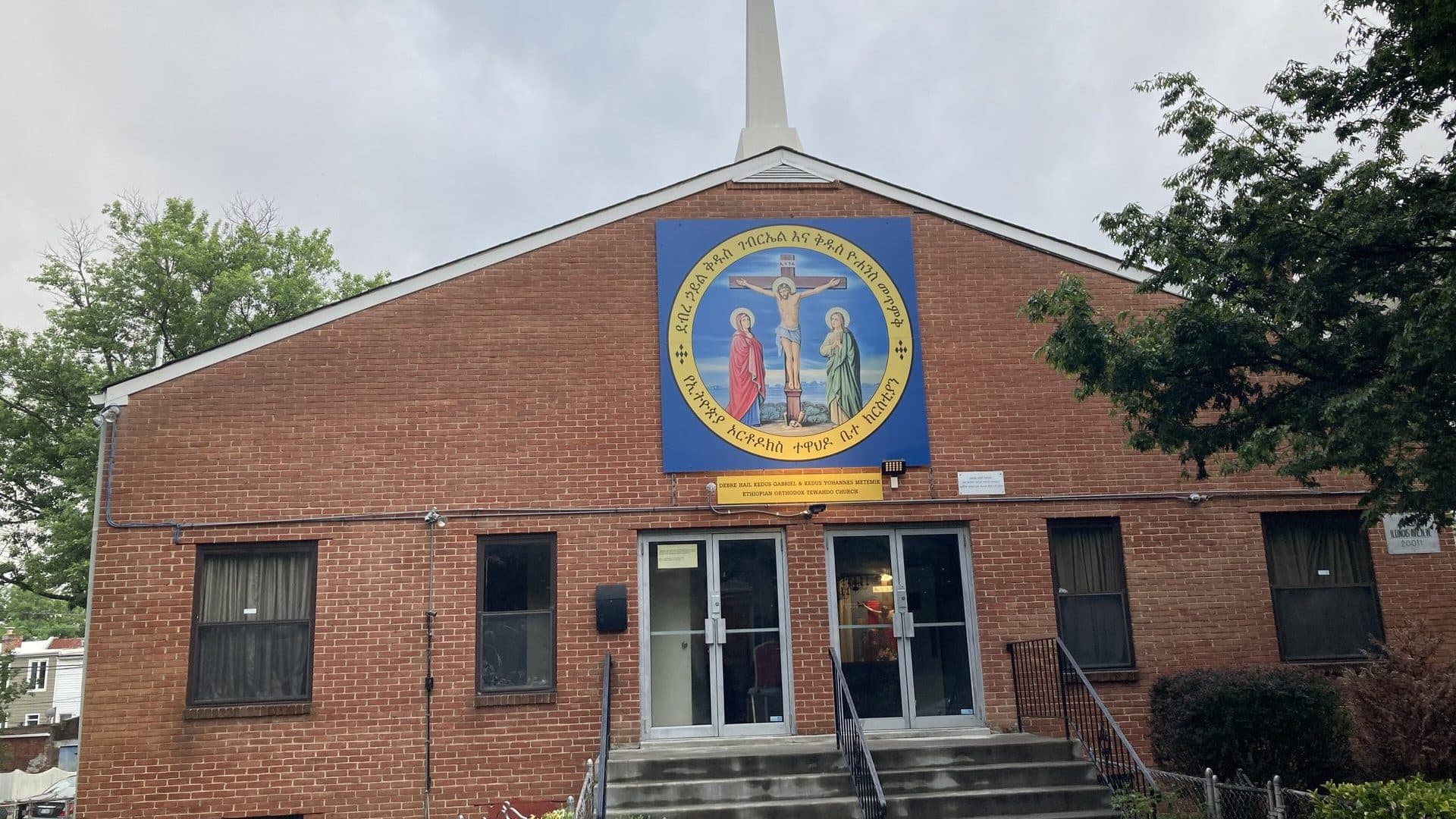 The brick front of Debre Hail Kedus Gabriel and Kedus Yohannes Ethiopian Orthodox Church in Petworth, Washington, D.C., with a large icon of the Crucifixion above the doors
